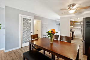 Dining area featuring ceiling fan, light wood finished floors, and baseboards