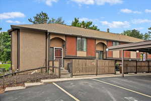View of property featuring uncovered parking