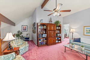 Living area/loft with light colored carpet, ceiling fan, high vaulted ceiling, beam ceiling