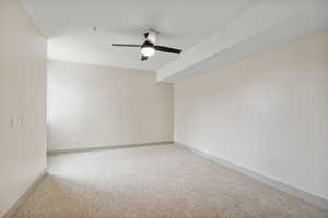 Unfurnished room with light colored carpet and ceiling fan