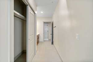 Hall featuring baseboards and recessed lighting