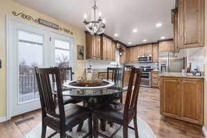 Dining room featuring plenty of natural light, a chandelier, light wood-style flooring