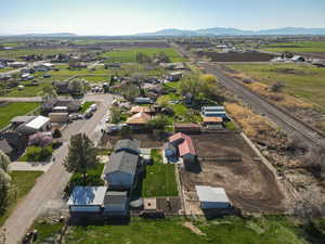 Aerial overview of property's location featuring rural landscape, a mountain backdrop, and nearby suburban area