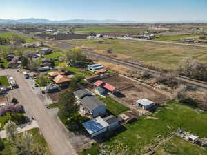 Aerial view of property and surrounding area with rural landscape and a mountain backdrop