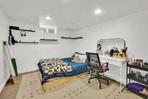 Bedroom featuring wood finished floors, baseboards, and recessed lighting