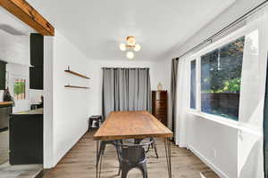 Dining room featuring a textured ceiling, light wood-style floors, and a chandelier