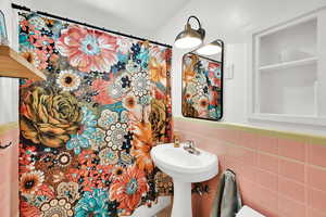 Bathroom with tile walls and a sink