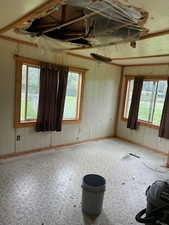 Empty room with plenty of natural light and wooden walls