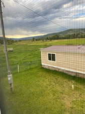 Yard at dusk featuring a rural view
