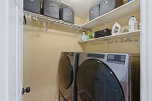 Laundry area with washer and clothes dryer