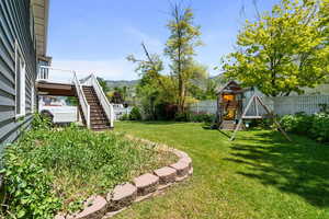 View of yard featuring a playground, stairs, and a mountain view