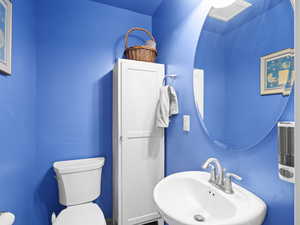 Half bath with a sink and toilet