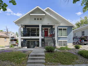 Arts and Crafts style home built from the ground up in past 10 years with View of front facade with stairs, covered porch, and stucco siding