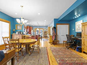 Dining room featuring plenty of natural light, light wood-style flooring, a chandelier, and recessed lighting