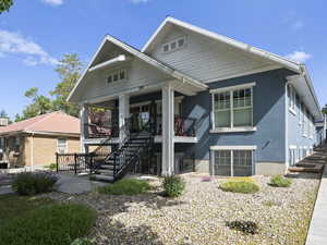 View of front of home featuring stairs, stucco siding, and a porch