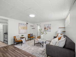 Living room with dark wood-style floors and baseboards