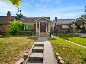 View of front of home with a front lawn and brick siding