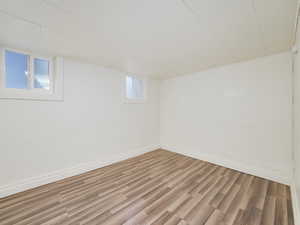 Basement featuring baseboards and wood finished floors