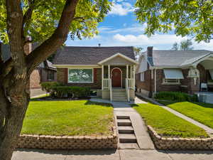 View of front of home featuring brick siding and a front yard