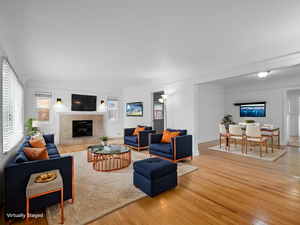 Living area featuring wood finished floors and a tiled fireplace