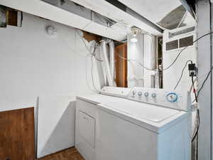 Clothes washing area featuring washer and dryer and laundry area