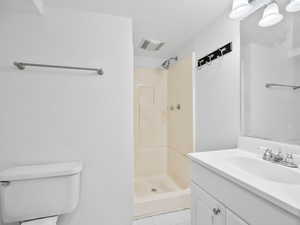 Bathroom with a shower stall, vanity, toilet, tile patterned flooring, and visible vents