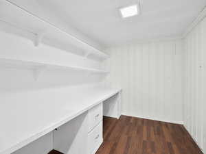Interior space featuring built in study area and dark wood finished floors