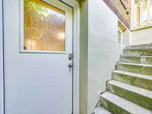Property entrance with stucco siding