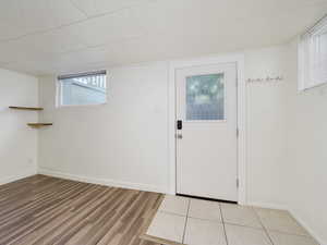 Foyer featuring light wood-style flooring, baseboards, and plenty of natural light