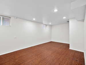 Below grade area with recessed lighting, baseboards, and dark wood-style flooring