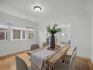 Dining space featuring light wood-style flooring and a textured ceiling