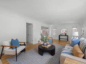 Living area featuring light wood-type flooring and a textured ceiling