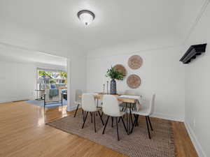 Dining space with wood finished floors and a textured ceiling