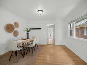 Dining area featuring light wood finished floors and a textured ceiling