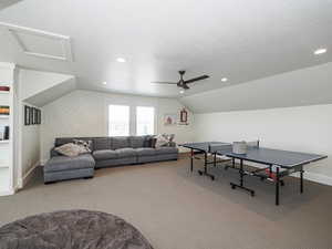 Recreation room featuring carpet flooring, baseboards, ceiling fan, lofted ceiling, and recessed lighting