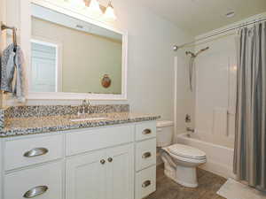 Bathroom with vanity, toilet, and shower / bath combo