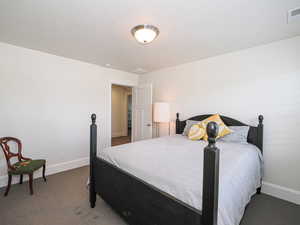 Carpeted bedroom with baseboards