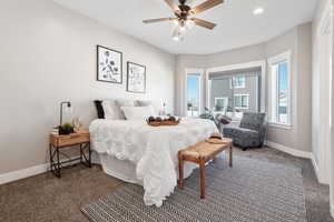Carpeted bedroom featuring recessed lighting and a ceiling fan