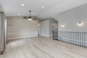 Unfurnished room featuring ceiling fan, wood finished floors, lofted ceiling, recessed lighting, and baseboards