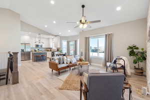 Living room featuring recessed lighting, light wood-style floors, a ceiling fan, and vaulted ceiling