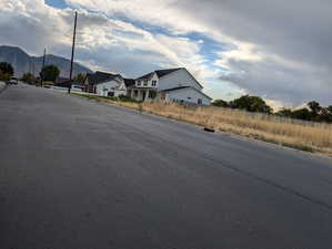 View of asphalt street with curbs and a mountain view