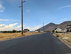 View of asphalt street with curbs and a mountain view