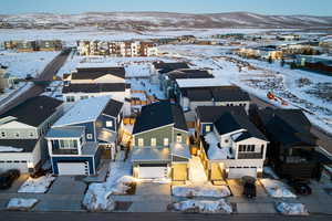 Snowy aerial view with a residential view and a mountain view