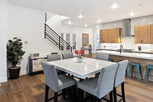 Dining space featuring wood finished floors, stairs, recessed lighting, and baseboards