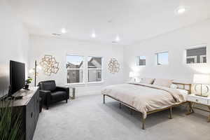 Bedroom featuring light colored carpet, recessed lighting, and baseboards