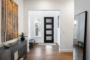 Foyer entrance featuring wood finished floors and baseboards