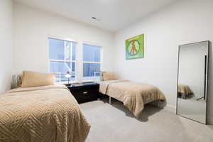 Bedroom with light carpet