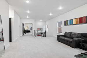 Living area featuring carpet, recessed lighting, and baseboards