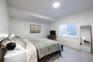 Bedroom featuring carpet flooring and baseboards