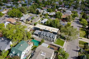 Aerial view of property and surrounding area with nearby suburban area